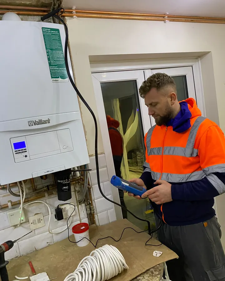 SCAF Gas Safe engineer testing a Vaillant ecoTEC boiler with a flue gas analyser